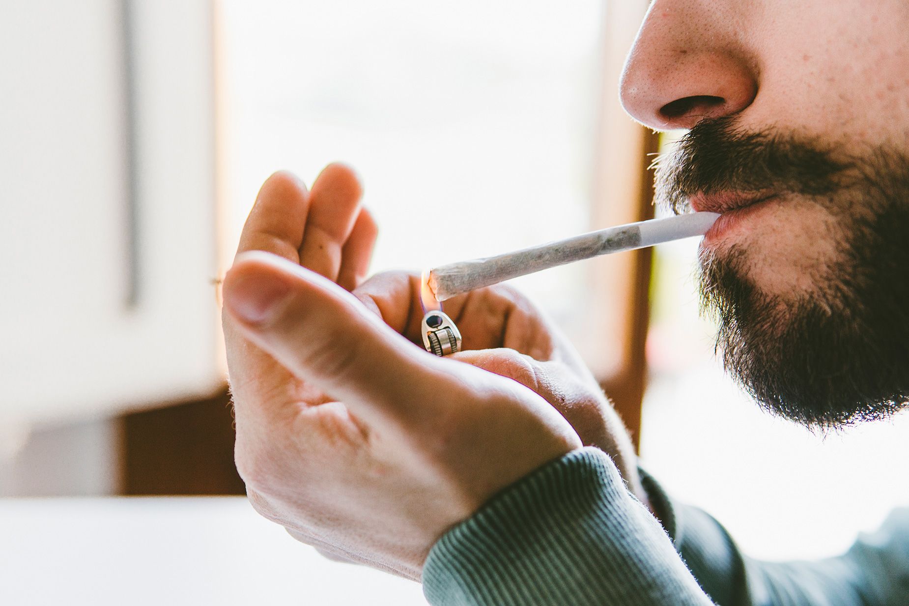 a guy lights a cigarette